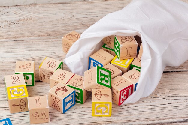 Multicolored wooden toy blocks on wooden table