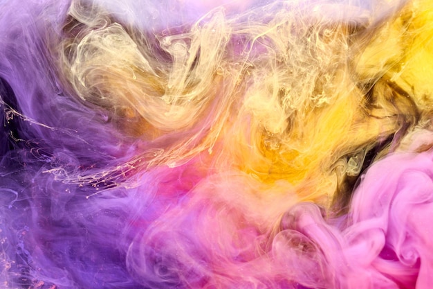 Multicolored yellow pink smoke abstract background acrylic paint underwater explosion