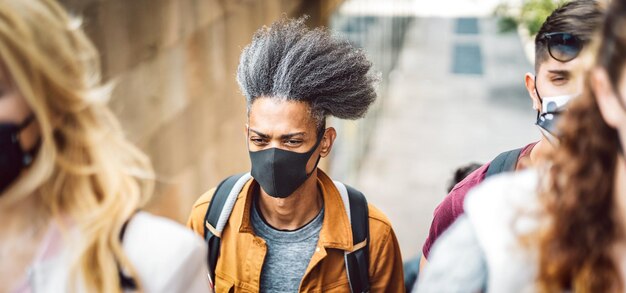 Multicultural crowd walking at city street during omicron pandemic wave