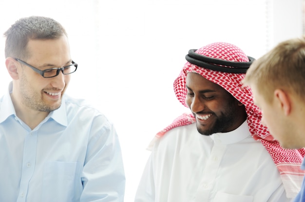 Multicultural different ethnic group working on laptop together