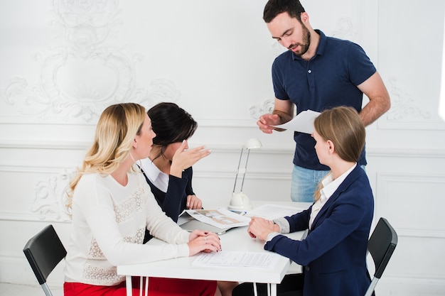 Multicultural team of designers looking at a project at work