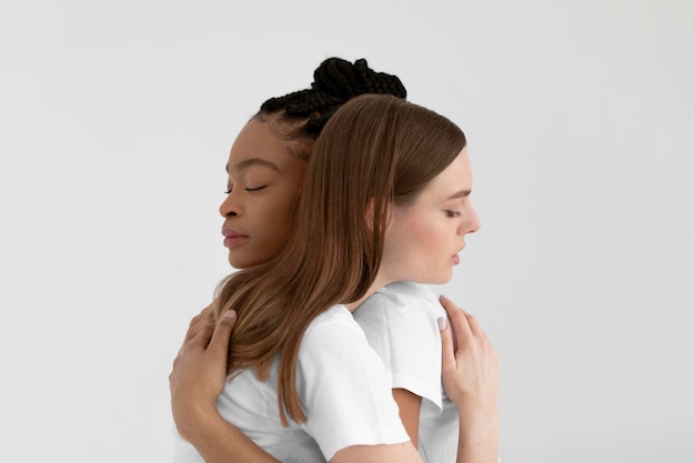 Multicultural women hugging close up