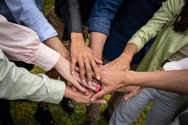 Multiculturele jongeren die de handen ineen slaan - concept voor eenheid en samenwerking