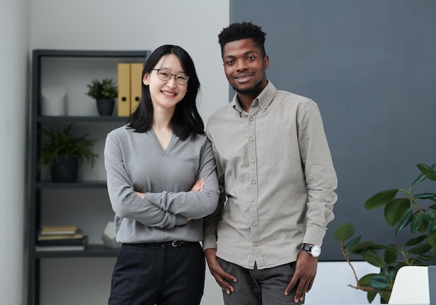 Multiethnic business couple working in office