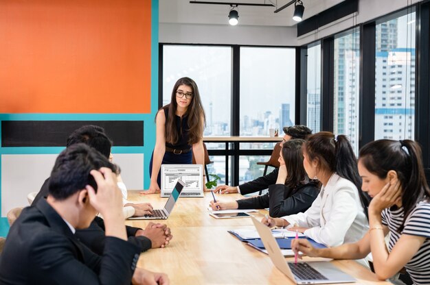 Multiethnic business team meeting with seriously about financial of company in modern office