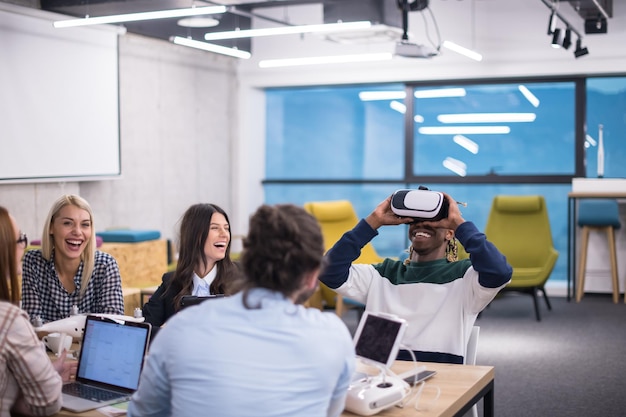 Multiethnic Business team using virtual reality headset in office meeting  Developers meeting with virtual reality simulator around table in creative office.