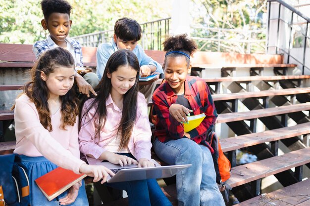 Multiethnic classmates working together on laptops diverse classmates using laptops