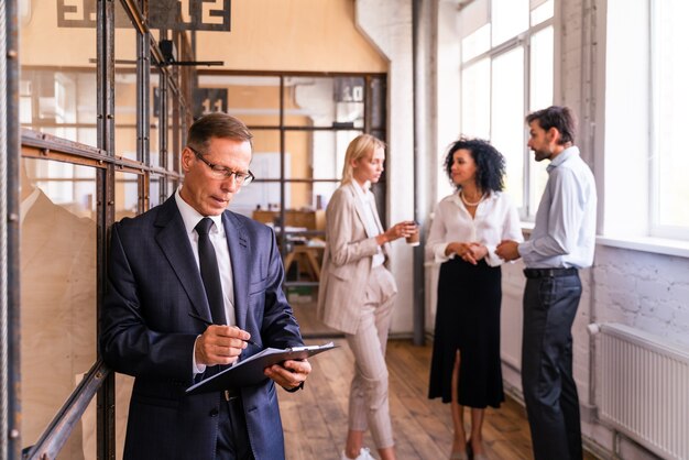 Multiethnic corporate business team meeting in the office for a strategic marketing plan - Office workers, entrepreneurs and company employee at work in a multinational company