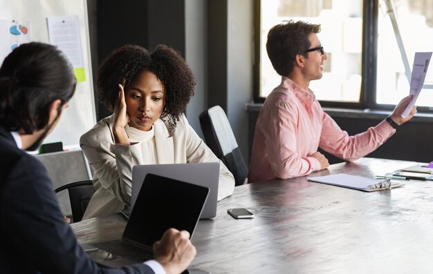 Multiethnic coworkers team sitting at conference hall have conversation