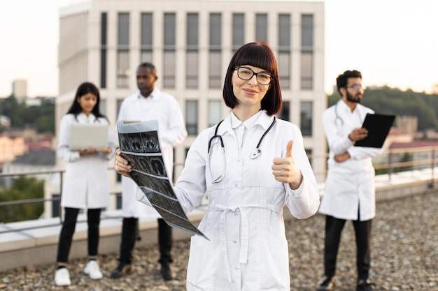 Photo multiethnic employees of clinic working on devices with results of examination