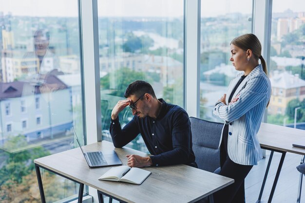 Multiethnic executive team discussing financial report while sitting at table in office Diverse business people businessmen planning to work together in a meeting room using a laptop computer