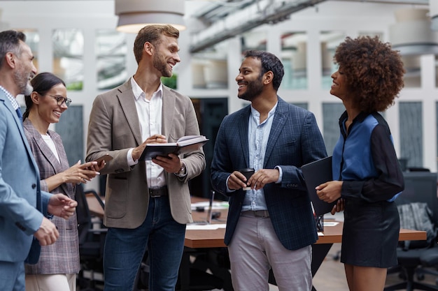 Photo multiethnic group of business people talking in office during break teamwork concept