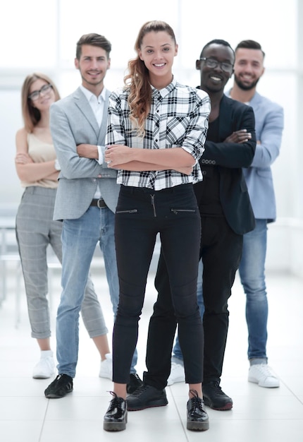 Multiethnic group of confident diverse business people standing looking at camera company ceo boss and employees posing in office together