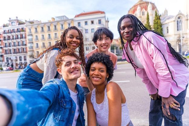 Multiethnic group of friends talking a selfie in the city