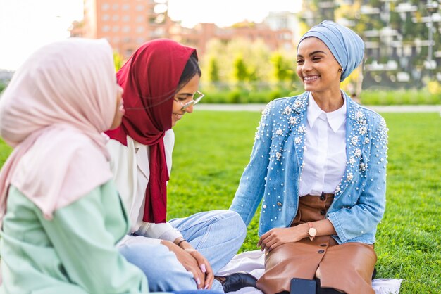 multiethnic group of muslim girls wearing casual clothes and traditional hijab bonding