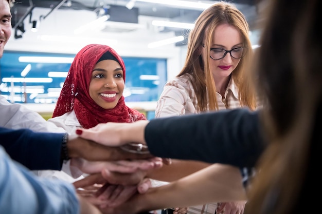 multiethnic Group of young business people celebrating success at their working places in startup office success and winning concept