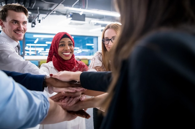 multiethnic Group of young business people celebrating success at their working places in startup office success and winning concept