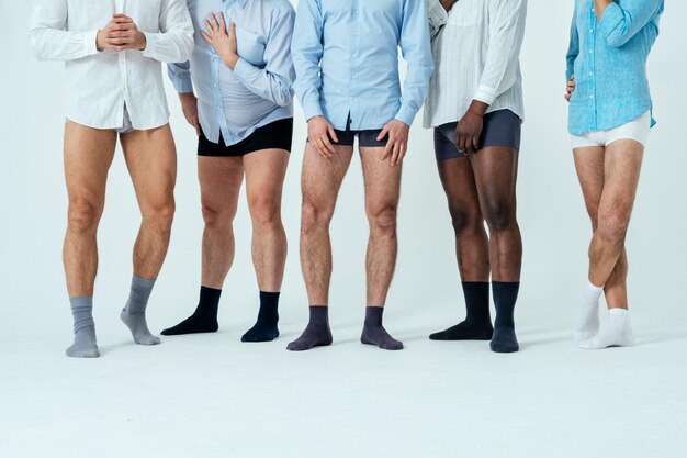 Multiethnic men posing for a male edition body positive beauty set.  guys with different age, and body wearing boxers underwear and shirt