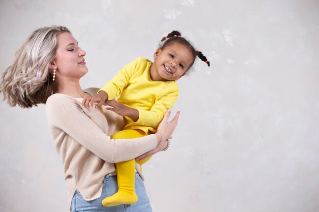 Multiethnic mom and daughter play at home