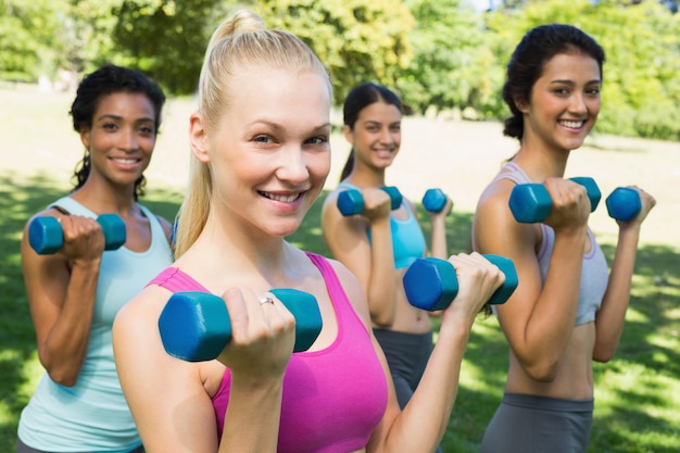 Multiethnic sporty women weightlifting