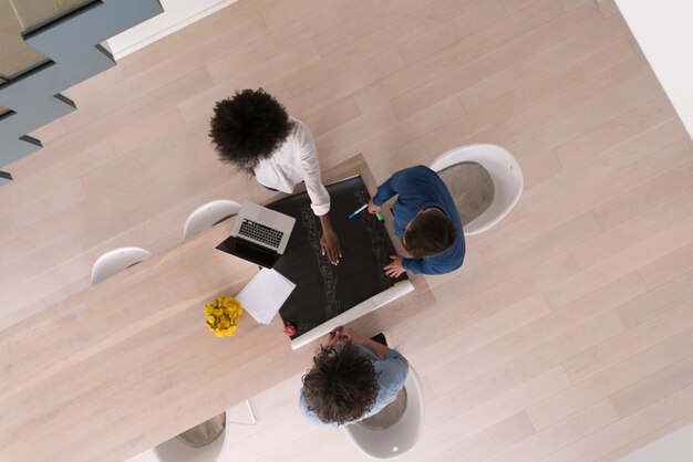 Multiethnic startup business team on meeting in modern bright office interior brainstorming, top view