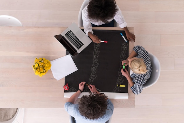 Multiethnic startup business team on meeting in modern bright office interior brainstorming, top view