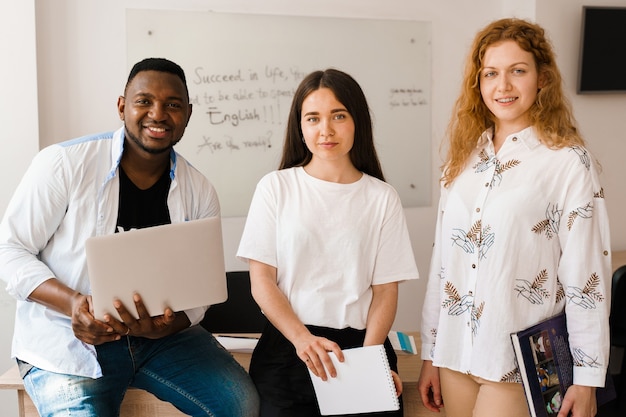 Multiethnic students and teacher study foreign languages together in class