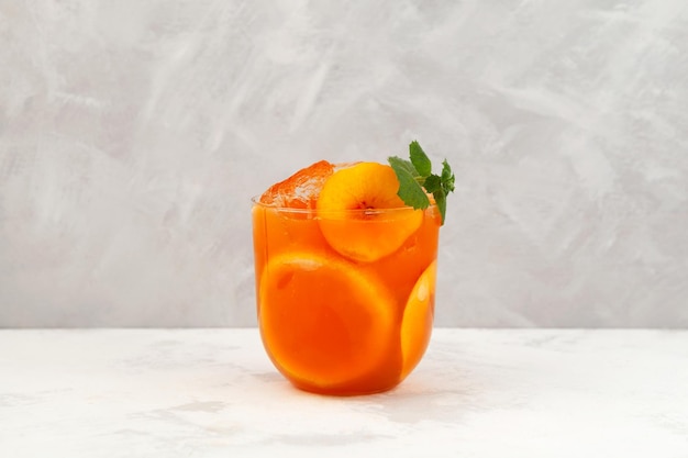 Multifruit tropical cocktail with natural mango juice fruit pulp and peach pieces Healthy smoothie