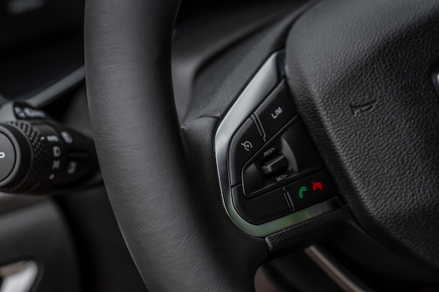 Multiple buttons on the steering wheel to accept or reject calls from the phone close up view. Answer and reject phone buttons.