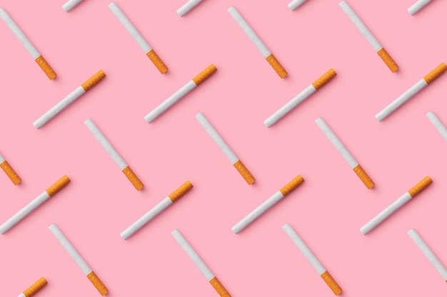 Multiple cigarettes organized in a row over pink background