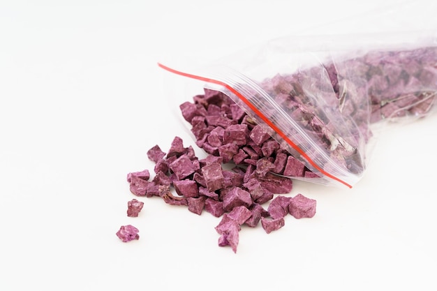 Multiple dried purple sweet potatoes on white background