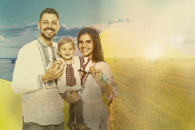 Multiple exposure of happy family wearing national clothes wheat field and Ukrainian flag