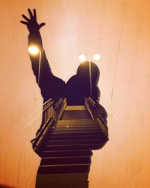 Photo multiple image of silhouette man with staircase at night