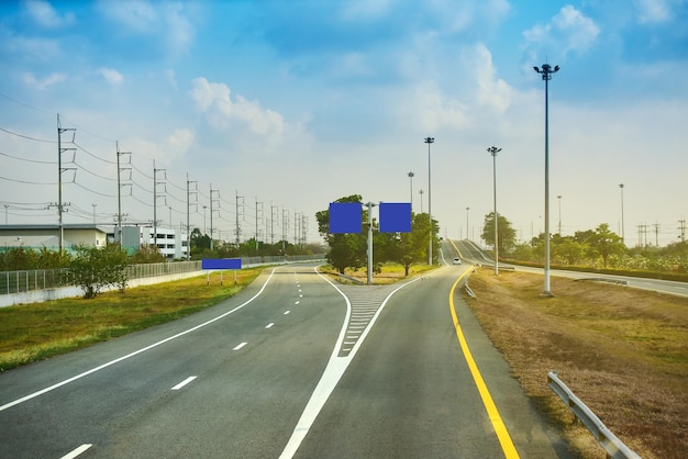 Multiple lane highway against cloudy sky