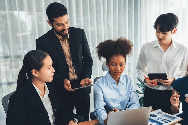 Multiracial analyst team use BI dashboard data to analyze financial report on meeting table Group of diverse business people utilize data analysis by FIntech for success business marketing Concord