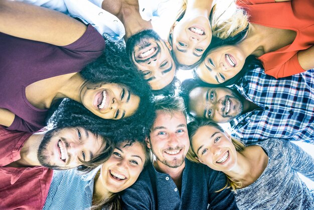 Multiracial best friends millennials taking selfie outdoors with back lighting