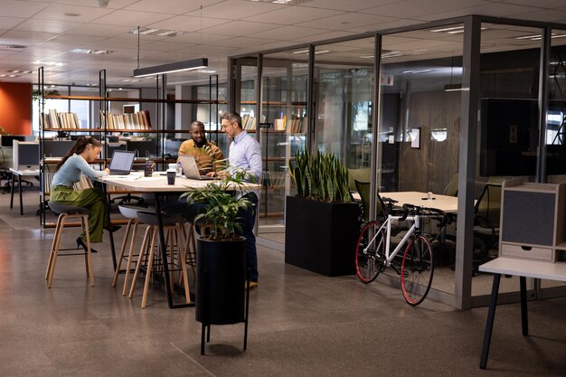 Multiracial businessmen discussing during meeting by businesswoman working at modern office