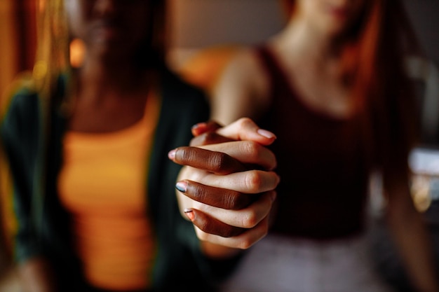 Multiracial couple girlfriends in love embracing in room