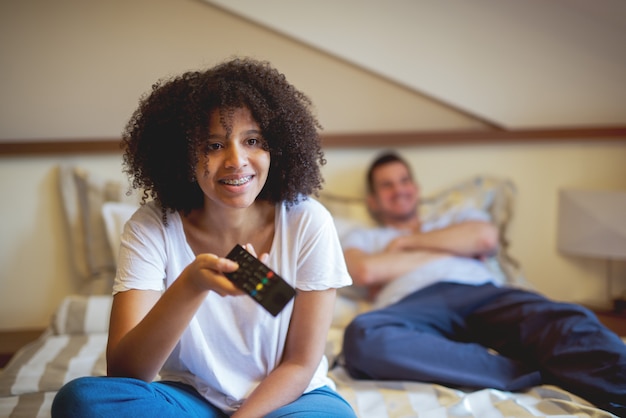 Multiracial couple watching TV.