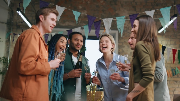 Multiracial coworkers talking party in office happy colleagues team celebrating