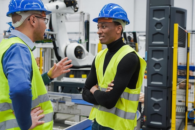 Photo multiracial engineer men working inside robotic factory