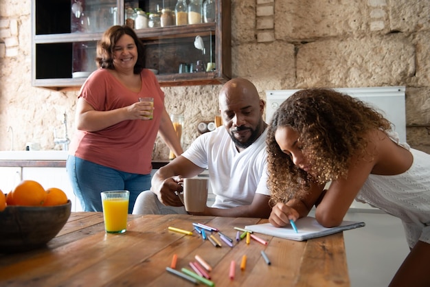 multiracial family in the kitchen of their home sharing moments together