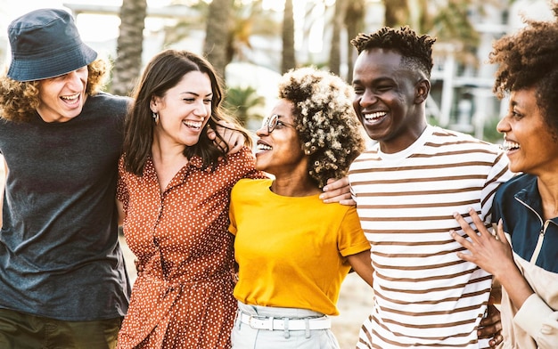 Multiracial friends having fun hanging outside together