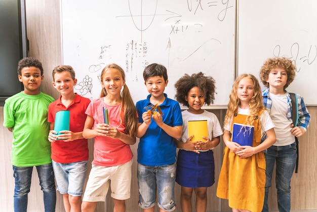 写真 小学校の子供たちの多民族グループ-教師やクラスメートと一緒に学校の時間とレッスンを楽しんでいる遊び心のある学校の生徒