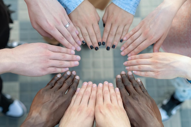 Multiracial human hands making a circle Group of Diverse Multiethnic People Teamwork Friendship concept