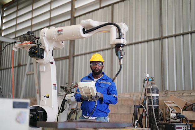 Multiracial industrial engineers working at automated AI robotic production factory New industrial technology concept