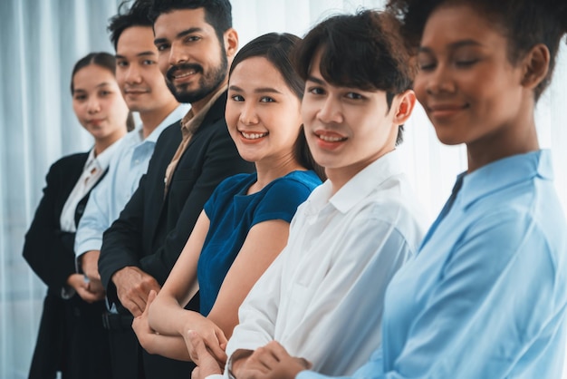 Multiracial office worker hold hand in a line promoting synergy Concord