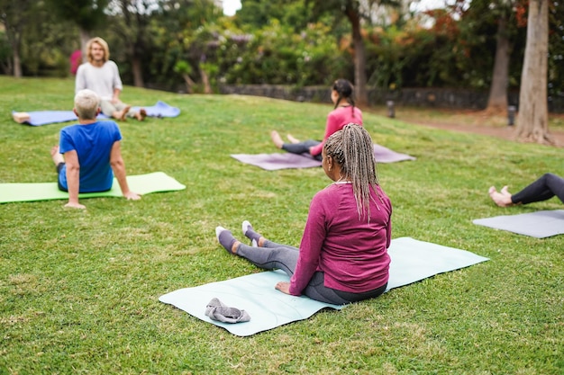 Multiracial people doing yoga exercise outdoor