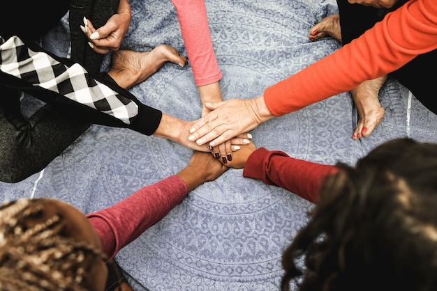 Photo multiracial people stacking hands outdoor at city park