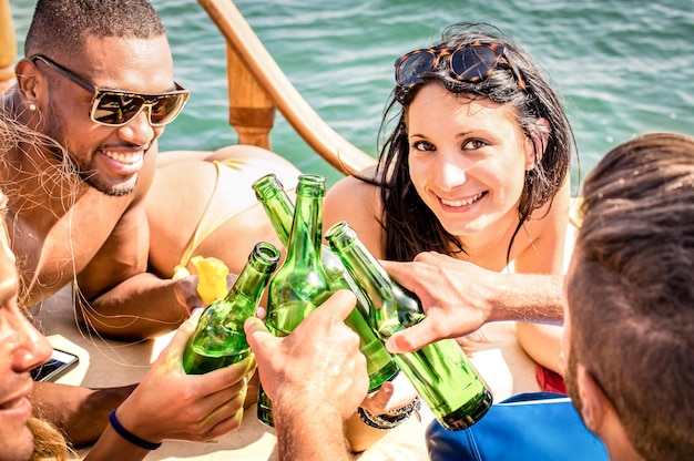 Multiracial people on yacht drinking together